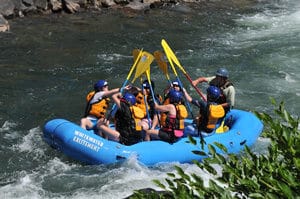 Middle Fork American River Rafting group in raft with paddles in the air on middle fork american river rafting california