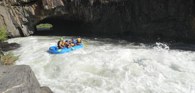 rafters on white water entering tunnel on middle fork american river