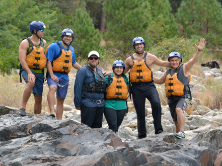 6 rafters standing on rock near the american river