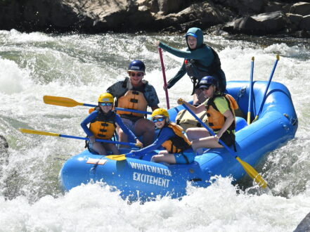 A Family paddling through a fun rapid on the South Fork American River