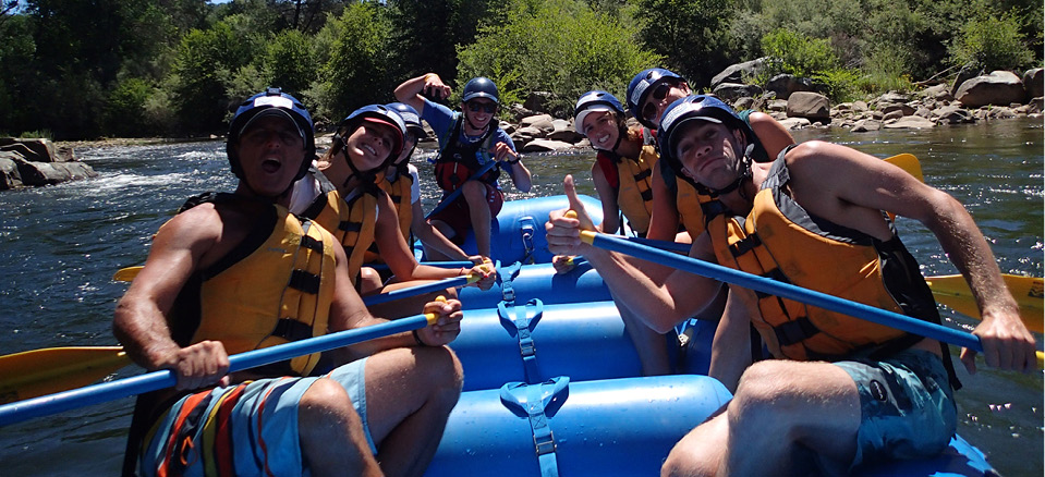 bachelor party happy on their raft holding paddles