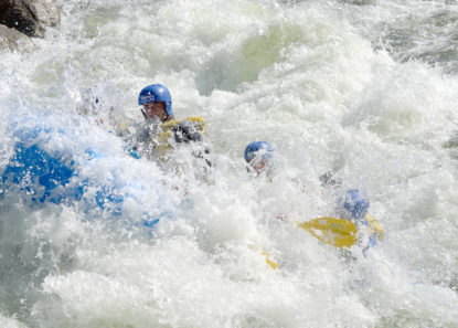a wave crashing into raft