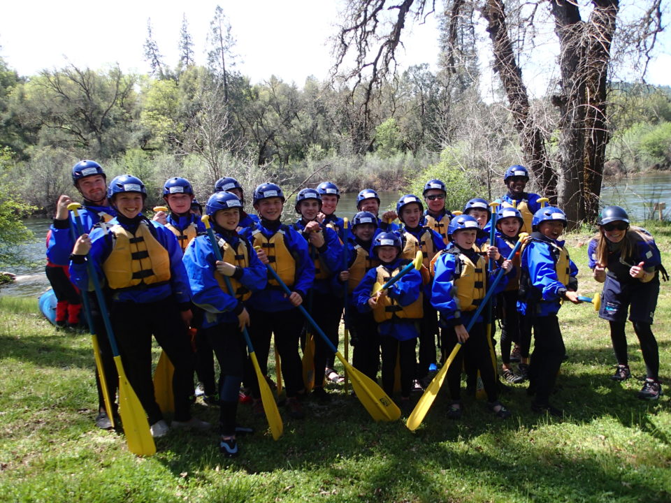 boy scout group with life jackets and paddles ready to go rafting