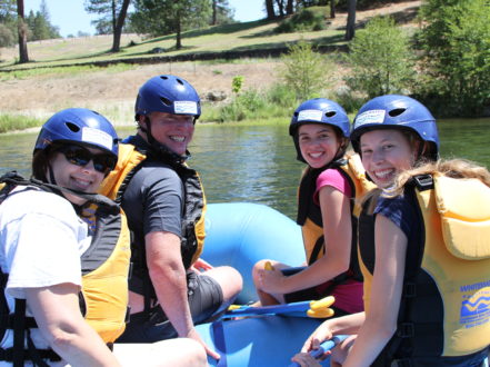 best place to go white water rafting - family sitting in raft on south fork american river