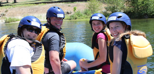 best place to go white water rafting - family sitting in raft on south fork american river