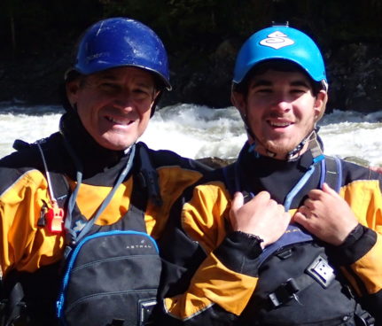 Norm and Phillip in whitewater gear in front of river