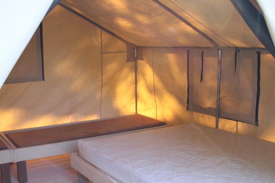 inside of canvas cabin tent on the river