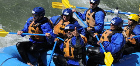 people on moving raft one giving thumbs up