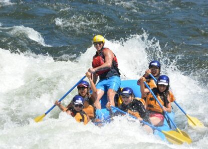 A boat rafting through a rapid